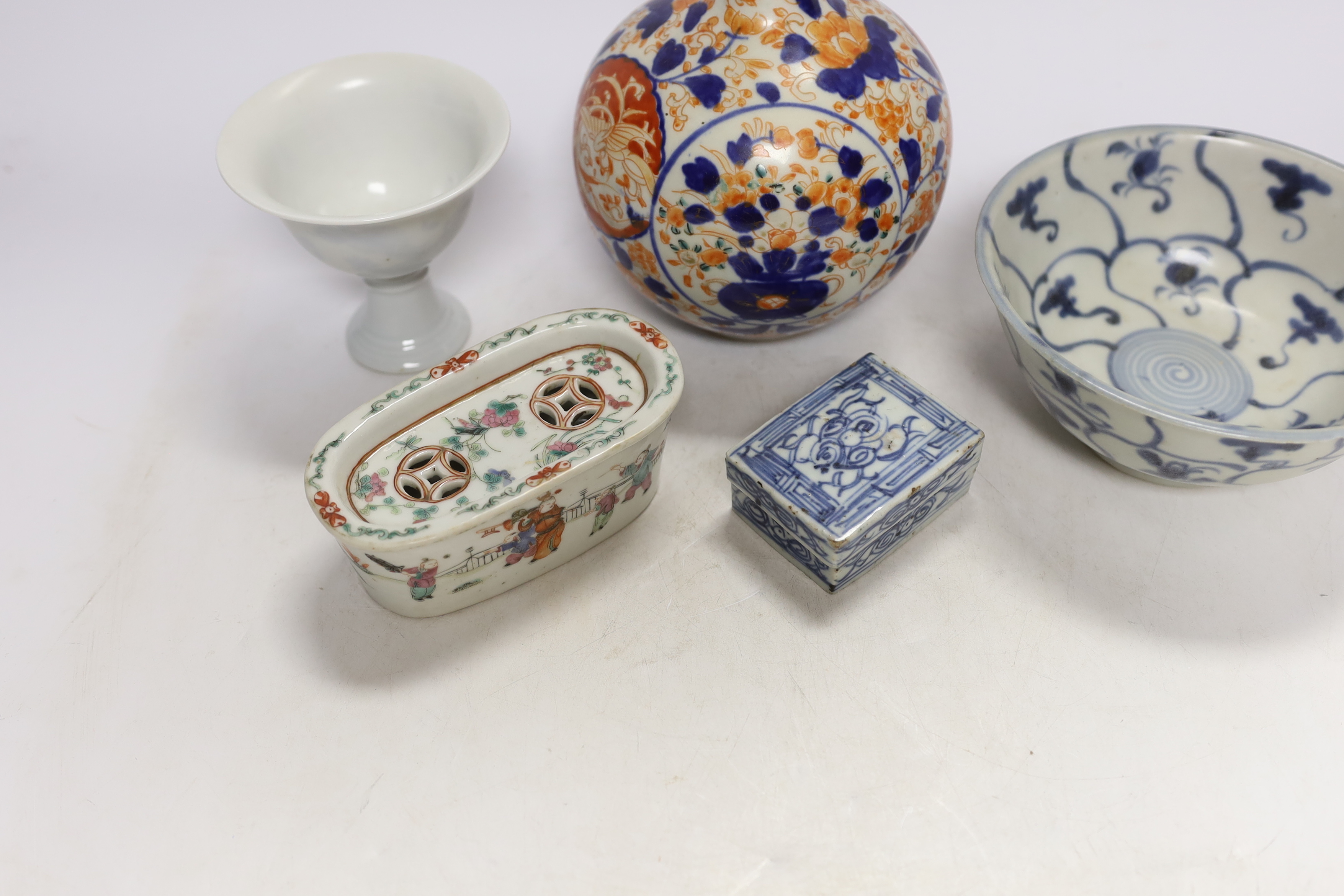 A Chinese Tek Sing Cargo bowl, a Chinese famille Rose Jar and cover, late 19th century, a stem cup with hidden decoration a box and cover and a Japanese Imari bottle vase.